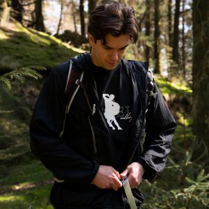 Graphic streetwear t-shirt under a jacket being zipeed up