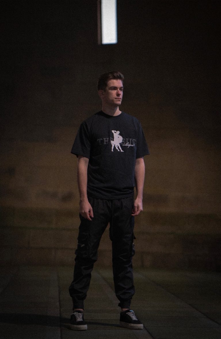 Man wearing theseus tshirt in the street at night