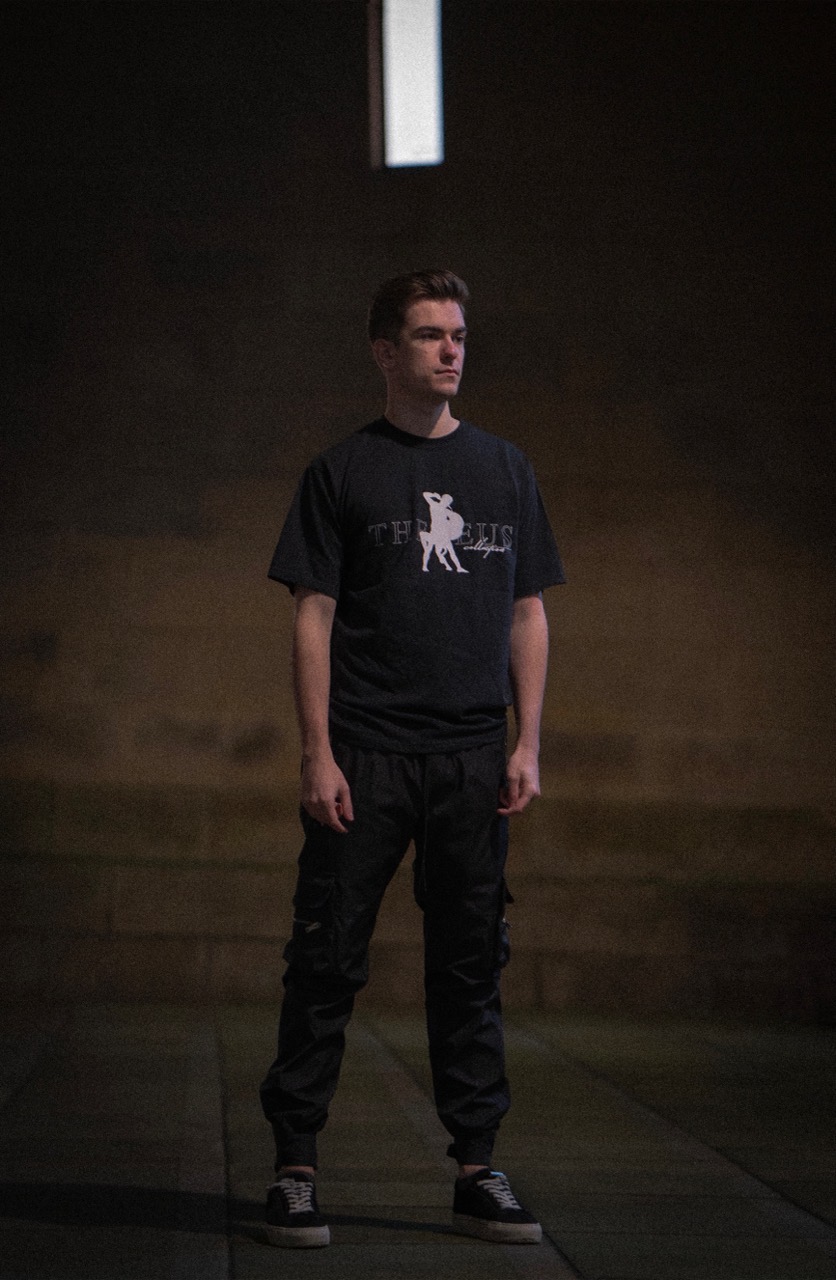 Man wearing greek mythology theseus t-shirt at night